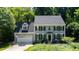 Charming home with a two-car garage, surrounded by mature trees and flowering bushes at 113 Bergeron Way, Cary, NC 27519