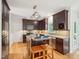 Gourmet kitchen featuring dark cabinets, granite countertops, and stainless steel appliances at 113 Bergeron Way, Cary, NC 27519