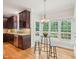 Eat-in kitchen with dark wood cabinets, stainless steel appliances and breakfast nook at 113 Bergeron Way, Cary, NC 27519
