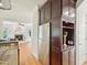 An open kitchen boasts stainless steel appliances, dark wood cabinets, and hardwood floors at 113 Bergeron Way, Cary, NC 27519