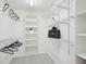Walk-in closet with built in shelving, hanging racks and carpeted floor at 113 Bergeron Way, Cary, NC 27519