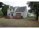 Exterior view of the home highlighting the deck, lush backyard, and gray siding at 114 Calebra Way, Cary, NC 27519
