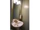 Small bathroom with a pedestal sink and a modern gold faucet at 114 Calebra Way, Cary, NC 27519