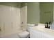 Bathroom with a white sink vanity, toilet, and shower-tub combo at 114 Calebra Way, Cary, NC 27519