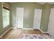 Bedroom that features wood floors, two doors, and a window for natural light at 114 Calebra Way, Cary, NC 27519