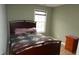 Bedroom featuring a bed with a patterned coverlet, a window and a dresser at 114 Calebra Way, Cary, NC 27519