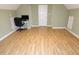 Spacious bedroom with sleek, wood-look flooring, light green walls, and ample natural light at 114 Calebra Way, Cary, NC 27519