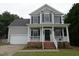 Charming two-story home with a welcoming front porch and well-maintained landscaping at 114 Calebra Way, Cary, NC 27519