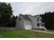 View of home from the side, showing yard, gray siding, fence, and attached garage at 114 Calebra Way, Cary, NC 27519