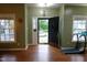 Bright foyer featuring a dark front door and hardwood floors at 114 Calebra Way, Cary, NC 27519