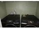 Clean laundry room with front-loading Samsung washer and dryer at 114 Calebra Way, Cary, NC 27519