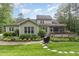 Exterior view of the landscaped backyard featuring a deck, screened porch and patio at 114 Margaret Mann Way, Pittsboro, NC 27312