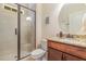Bathroom features a glass door shower and granite countertop vanity with an oval mirror at 114 Margaret Mann Way, Pittsboro, NC 27312