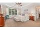 Spacious bedroom featuring a tray ceiling, a window and matching night stands at 114 Margaret Mann Way, Pittsboro, NC 27312