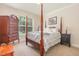Bedroom featuring a four poster bed, neutral walls, and a window providing natural light at 114 Margaret Mann Way, Pittsboro, NC 27312