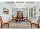 Elegant dining room featuring hardwood floors, coffered ceilings, and a stylish chandelier at 114 Margaret Mann Way, Pittsboro, NC 27312