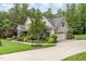 Well-maintained home featuring a side-entry garage, manicured lawn, and beautiful landscaping at 114 Margaret Mann Way, Pittsboro, NC 27312