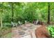 Outdoor firepit area with stone pavers and seating at 114 Margaret Mann Way, Pittsboro, NC 27312