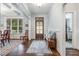 Elegant foyer with hardwood floors, coffered ceilings, natural light, and neutral color palette at 114 Margaret Mann Way, Pittsboro, NC 27312