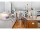 Well-equipped kitchen with granite countertops, center island, and stainless steel appliances at 114 Margaret Mann Way, Pittsboro, NC 27312