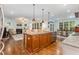 Open kitchen with granite island providing sink, and sight lines to living and eating areas at 114 Margaret Mann Way, Pittsboro, NC 27312
