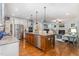 Open kitchen with large island overlooking the living room and stainless appliances at 114 Margaret Mann Way, Pittsboro, NC 27312