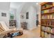 Comfortable living room with bookshelves and a leather recliner at 114 Margaret Mann Way, Pittsboro, NC 27312