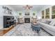 Inviting living room with a cozy fireplace, grand piano, and ample natural light at 114 Margaret Mann Way, Pittsboro, NC 27312
