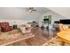 Spacious living room with hardwood flooring, bookshelves, an office area and seating at 114 Margaret Mann Way, Pittsboro, NC 27312