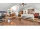 Spacious living room with a dining table, bookshelves, and a seating area with hardwood flooring at 114 Margaret Mann Way, Pittsboro, NC 27312