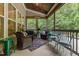 Inviting screened porch with comfortable seating, colorful rug and 