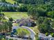 Aerial view showcasing a community clubhouse surrounded by a golf course at 1300 Heritage Club Ave, Wake Forest, NC 27587