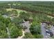 Aerial view of home surrounded by lush greenery with a golf course and convenient parking nearby at 1300 Heritage Club Ave, Wake Forest, NC 27587
