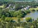 Scenic aerial shot of a pond with fountain, golf course and residential neighborhood at 1300 Heritage Club Ave, Wake Forest, NC 27587