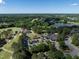 Community view of a golf course, clubhouse, pond, and wooded surroundings at 1300 Heritage Club Ave, Wake Forest, NC 27587