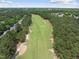Aerial view showcases a verdant golf course and surrounding community, all nestled in a picturesque setting at 1300 Heritage Club Ave, Wake Forest, NC 27587