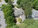 View of home highlighting the backyard patio, fire pit area, and lush landscaping at 1300 Heritage Club Ave, Wake Forest, NC 27587