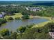Overhead shot of golf course neighborhood including pond and community features at 1300 Heritage Club Ave, Wake Forest, NC 27587
