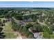 Picturesque aerial perspective of the golf course, pond, and surrounding homes in a serene community at 1300 Heritage Club Ave, Wake Forest, NC 27587