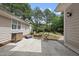 Private backyard featuring a stone patio, dining set and mature landscaping at 1300 Heritage Club Ave, Wake Forest, NC 27587