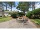 A backyard featuring a circular stone fire pit with chairs on a stamped concrete patio at 1300 Heritage Club Ave, Wake Forest, NC 27587