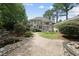 Spacious backyard with a stone patio, water feature, and fire pit at 1300 Heritage Club Ave, Wake Forest, NC 27587