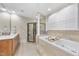 Elegant bathroom featuring a soaking tub, glass shower, and vanity at 1300 Heritage Club Ave, Wake Forest, NC 27587
