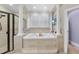 Luxurious bathroom showcasing a soaking tub and walk-in shower at 1300 Heritage Club Ave, Wake Forest, NC 27587