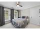 Cozy bedroom with natural light from two windows and gray curtains and a ceiling fan at 1300 Heritage Club Ave, Wake Forest, NC 27587