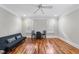 Bright bedroom featuring hardwood floors, white trim, and modern ceiling fan at 1300 Heritage Club Ave, Wake Forest, NC 27587