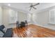 This bedroom features hardwood floors, a ceiling fan, and plenty of natural light at 1300 Heritage Club Ave, Wake Forest, NC 27587