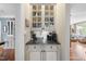 Charming butler's pantry features granite counters, white cabinets and glass-front display cases at 1300 Heritage Club Ave, Wake Forest, NC 27587