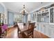 Bright dining room featuring chandelier, beautiful floors, large window and custom cabinets at 1300 Heritage Club Ave, Wake Forest, NC 27587