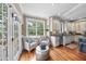 Bright eat-in kitchen boasts hardwood floors, white cabinetry, stainless steel appliances, and natural light at 1300 Heritage Club Ave, Wake Forest, NC 27587